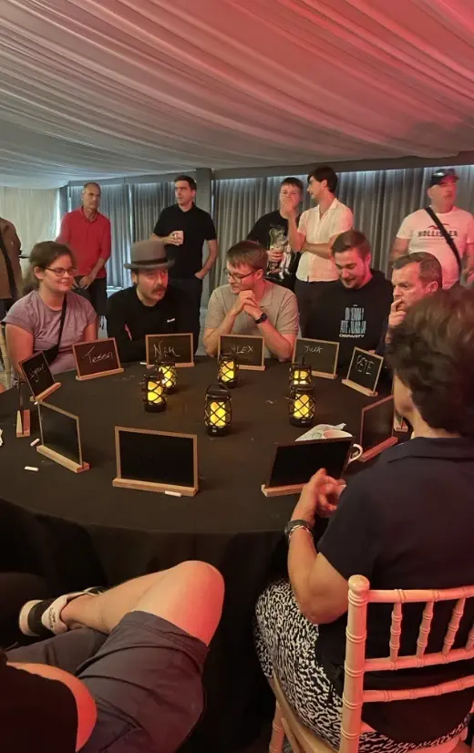 Employees around a table playing a game