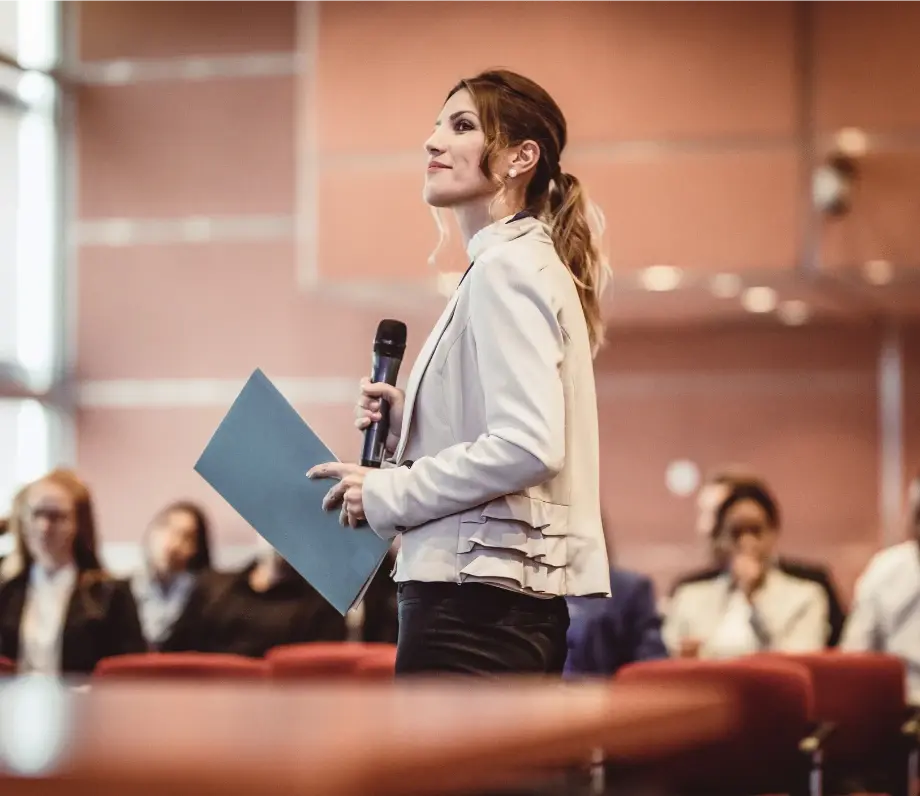 woman with microphone and notes