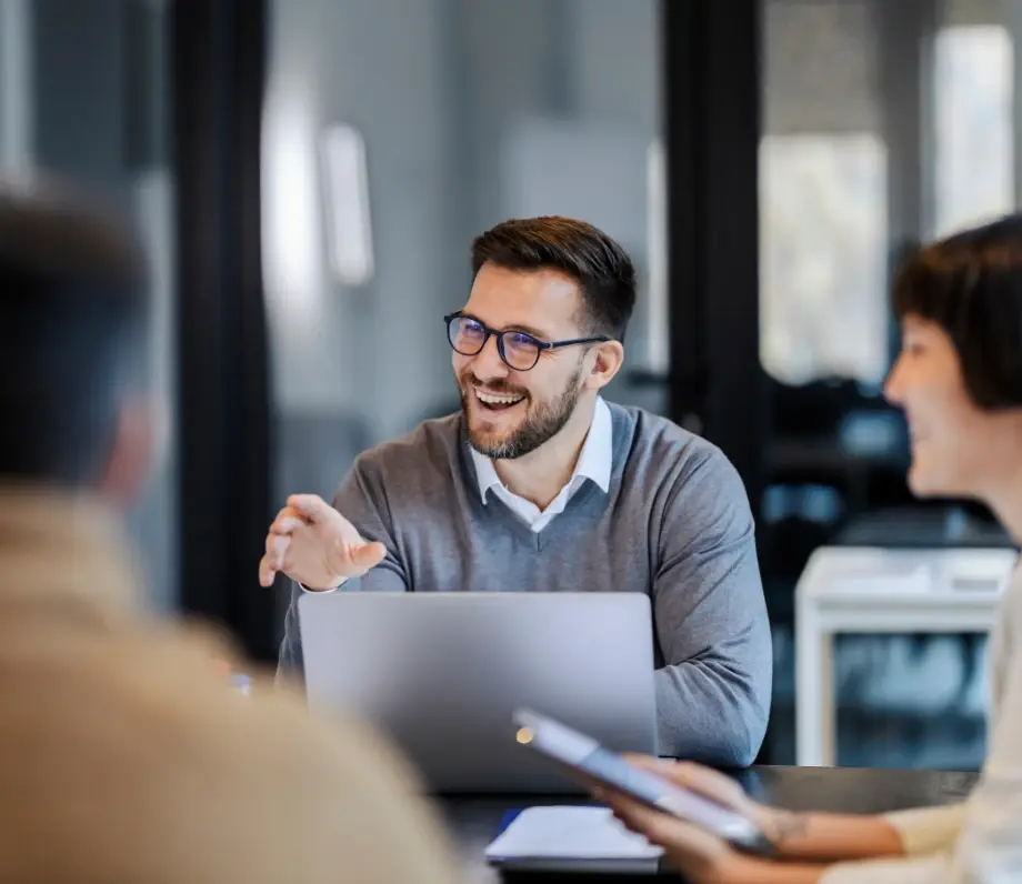 Man smiling at table with laptop