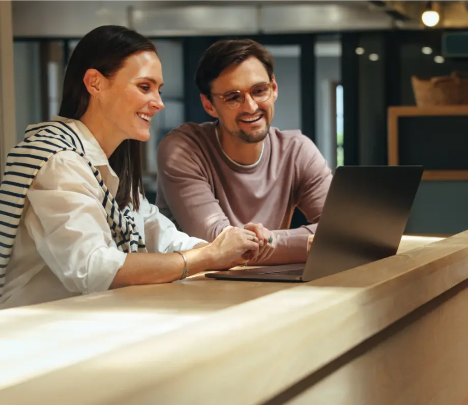 Man and woman looking at a laptop