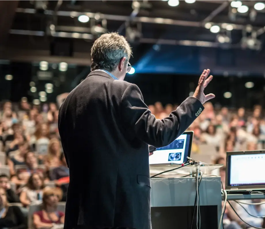 Man giving presentation to large room