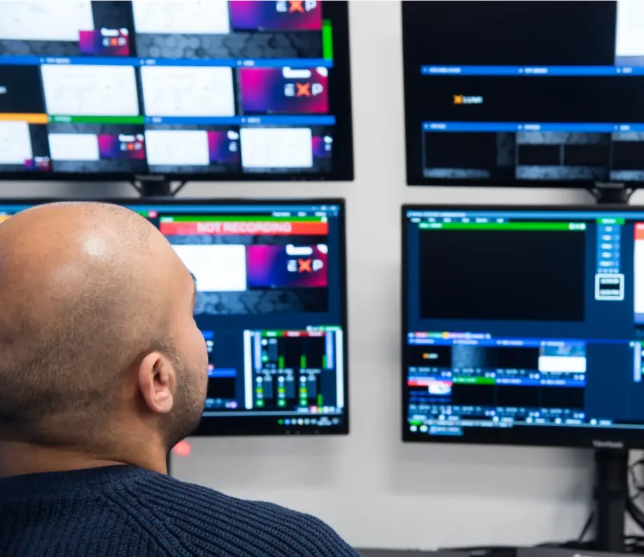 Man looking at multiple monitors