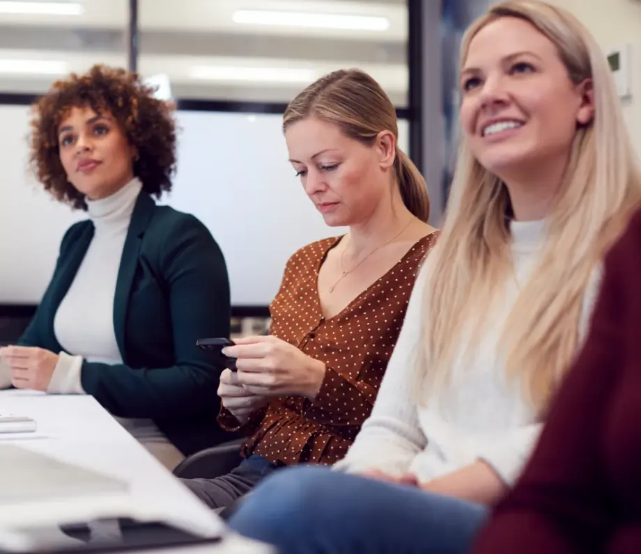 Three women at a meeting table